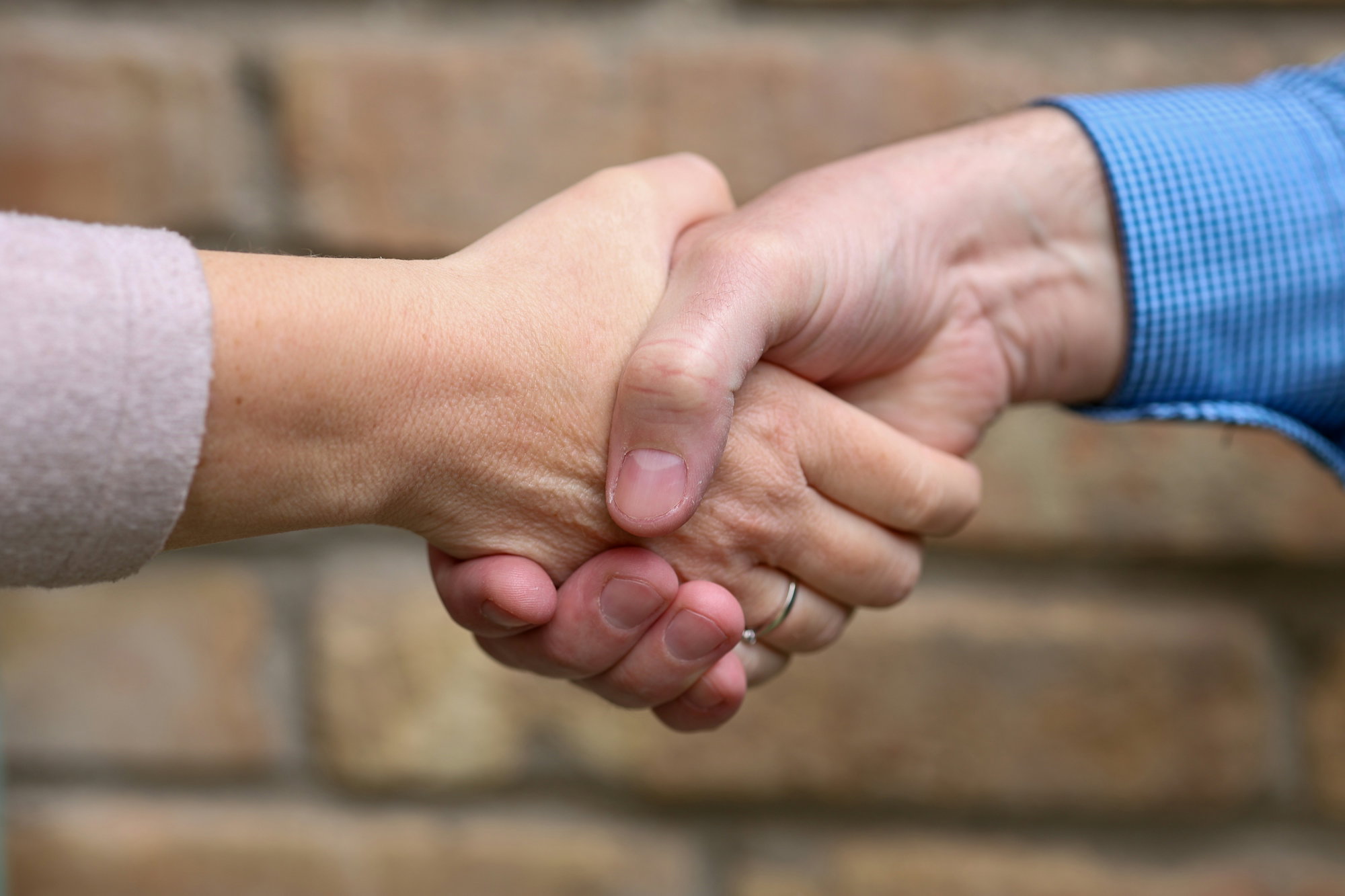 two-people-are-shaking-hands-.jpg Two people are shaking hands.